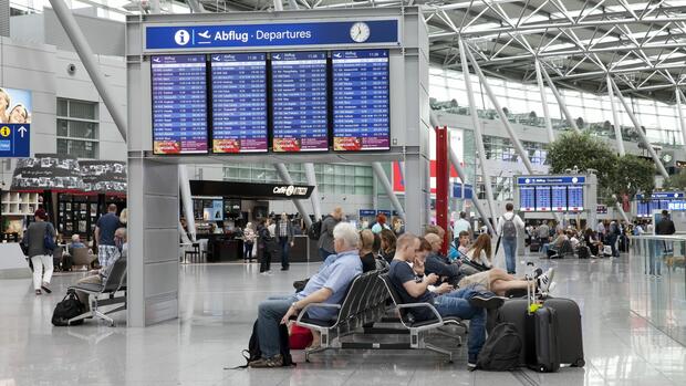 Menschen warten im Terminalgebäude des Flughafen Düsseldorf. Die Zahl der älteren Reisenden erhöht sich.