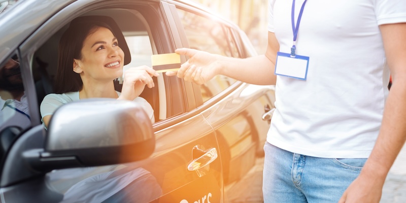 Frau bezahlt Mietwagen mit Kreditkarte - Symbolbild für Miles & More Kreditkarte wechseln und Alternativen AB